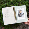 Open book with a plant-themed page held against a green outdoor background